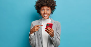women showing holding a smart phone with an appplication opend