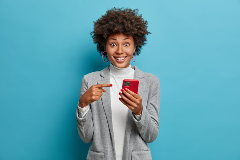women showing holding a smart phone with an appplication opend