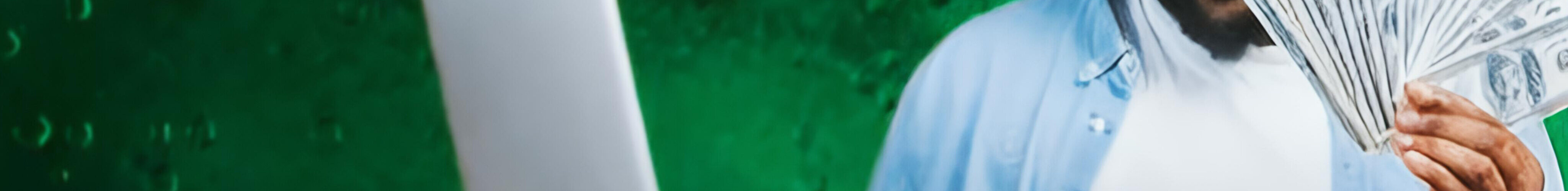 Man with his laptop and some cash at hand