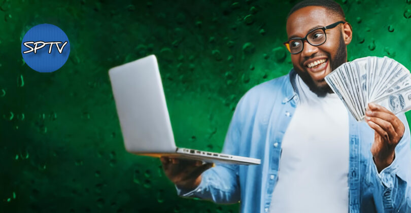 Man with his laptop and some cash at hand